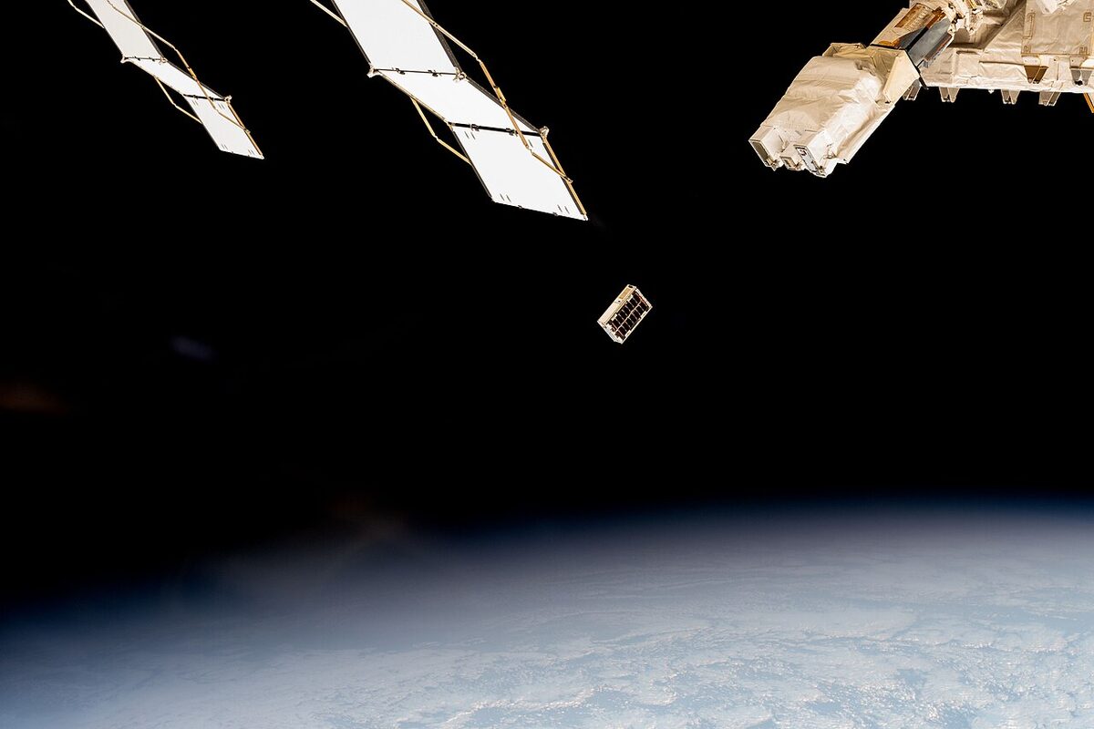A CubeSat is ejected into Earth orbit from a small satellite orbital deployer (iss072e351959)